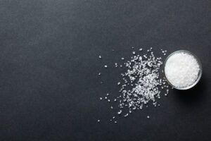 white salt on black background / blog - low sodium diet